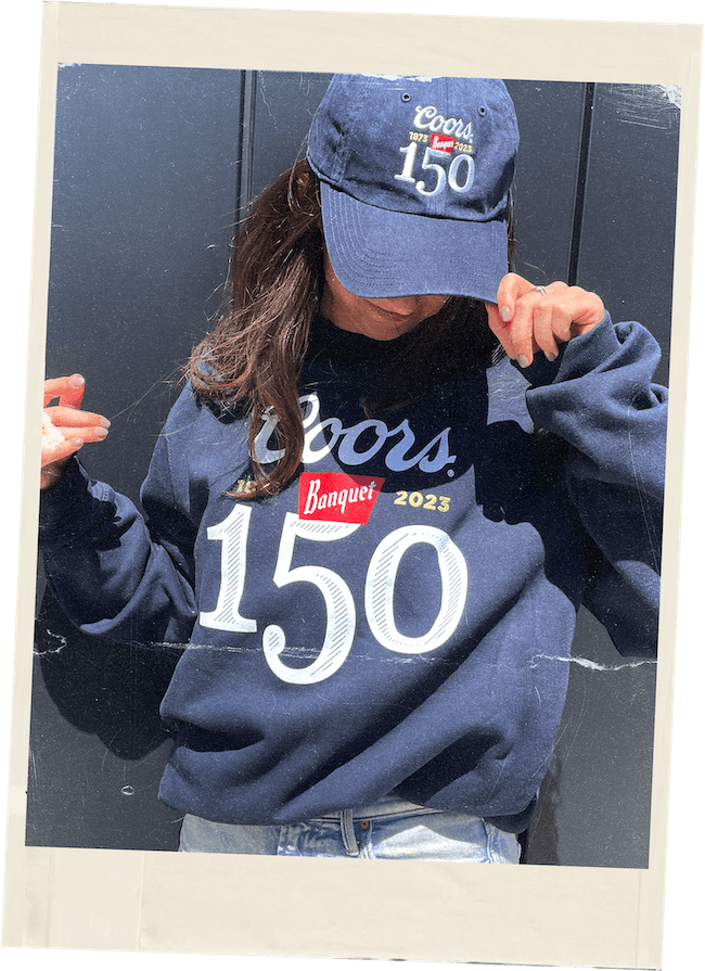 woman wearing a coors banquet cap and hoodie