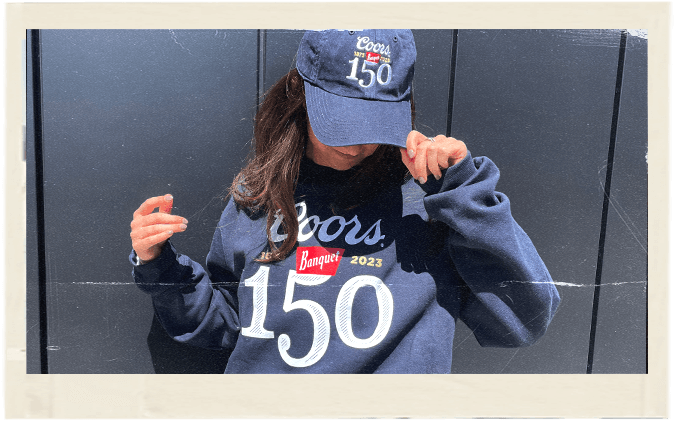 woman wearing a coors banquet cap and hoodie