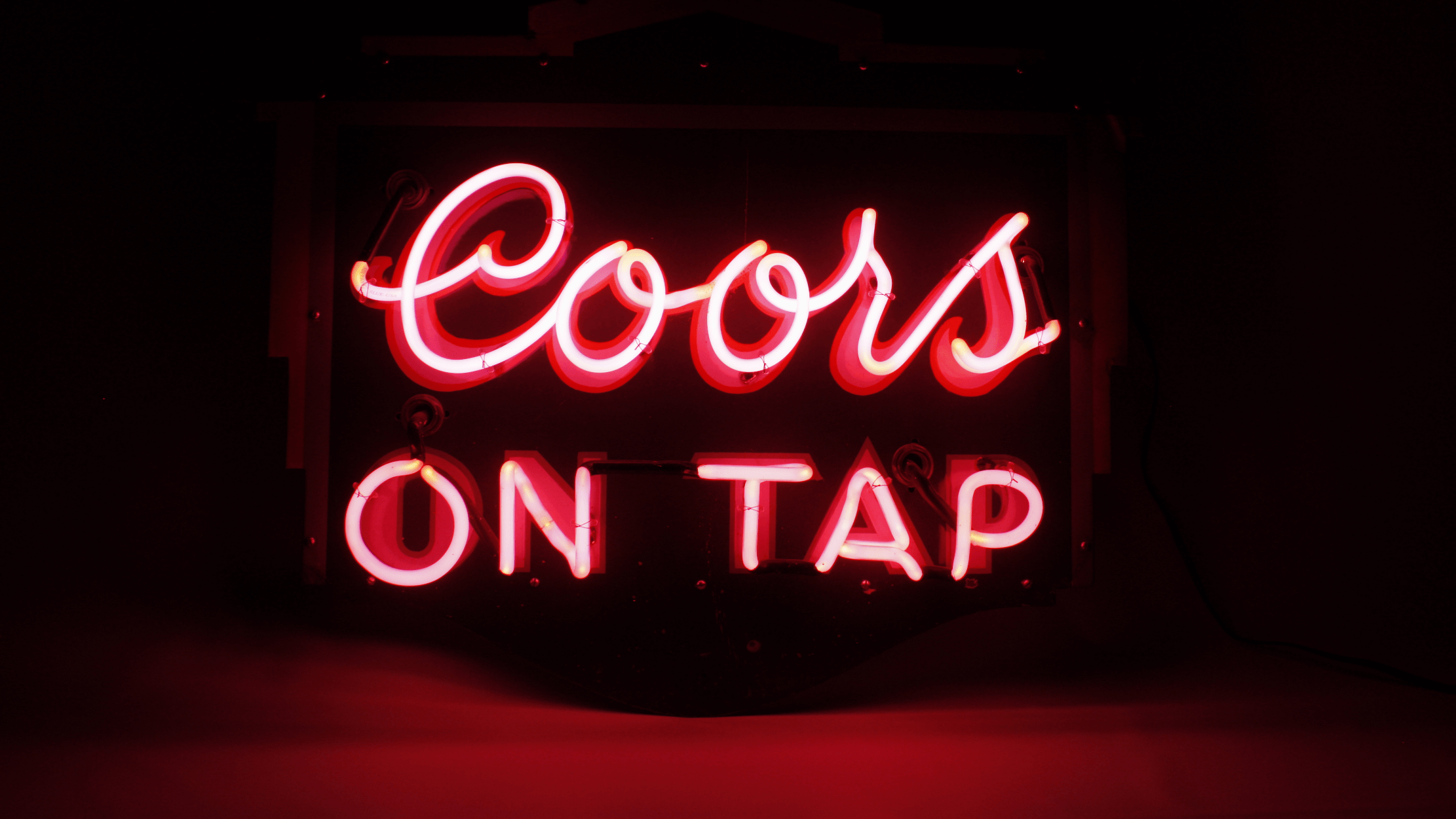 Coors On Tap Neon Sign light with dark red background